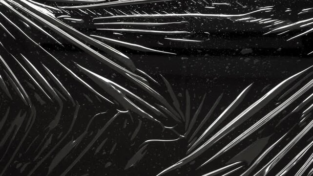 black crumpled and creased plastic bag texture background stop motion