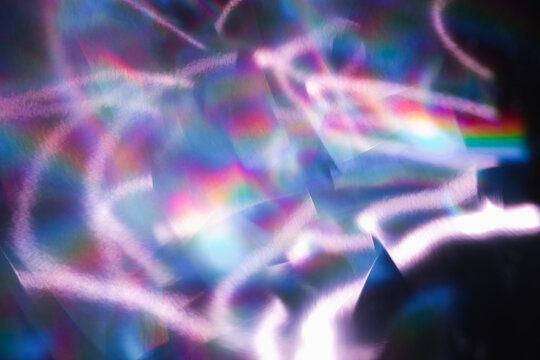 Soft colorful abstract background with blurred light reflections in purple, blue, and pink tones, creating a dreamy gradient texture.