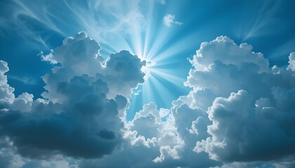 Sun rays shining through the clouds in a blue sky creating a beautiful and peaceful atmosphere