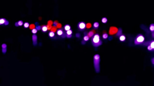 Colorful LED Bokeh Flickering and Reflecting on Water at Night View Background