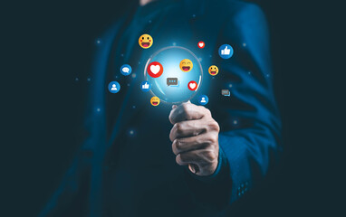 Businessman holding a virtual magnifying glass surrounded by social media icons, symbolizing digital marketing, social network analytics, online communication, customer engagement.