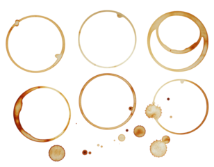 Various coffee cup stains in circular shapes, featuring different sizes and patterns, showcasing the remnants of liquid on a dark surface.