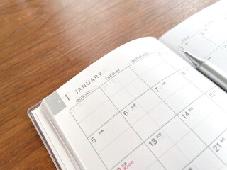 January planner open on a wooden table