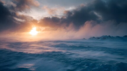 Dramatic winter sunrise over a windswept frozen landscape with swirling mist and clouds