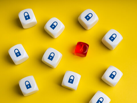 Minimal concept of cybersecurity with white dices showing padlock symbol and one red with key icon. Represents hacking, data breach, network vulnerability, and digital information protection.