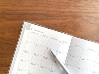 January planner open on a wooden table