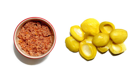 Pickled Thai young sour mango) served with spicy chili salt on a white background.