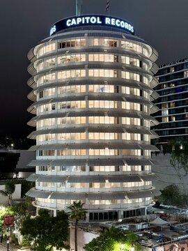 LOS ANGELES, CA, SEP 25, 2025: Close-up of Capitol Records building in Hollywood, showing detailed circular architecture with wrap-around balconies and glowing interior offices at dusk