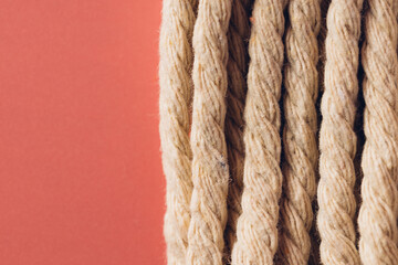 Natural Twisted Rope Against Vibrant Orange Background Texture