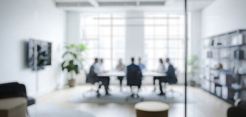 Blurred meeting in a modern bright office with people around a table, highlighting teamwork, discussion, and creativity in a collaborative workspace filled with light and energy.