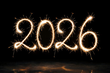 Bright sparkler fireworks spell out the year 2026 against a dark background