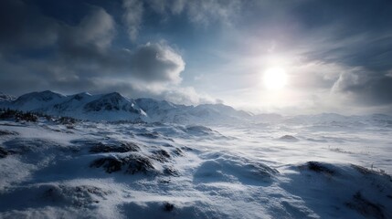 Obraz premium A bright sun illuminates a vast snowy mountain landscape under a dramatic cloudy sky