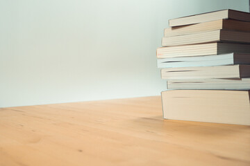 stack of book on table with soft focus library or bookstore background