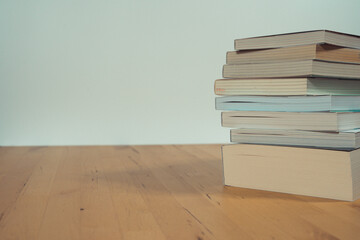 stack of book on table with soft focus library or bookstore background