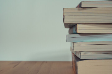 stack of book on table with soft focus library or bookstore background