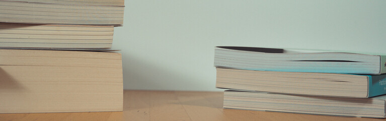 stack of book on table with soft focus library or bookstore background