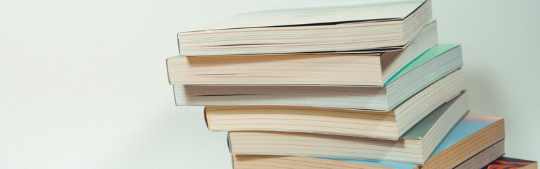 stack of book on table with soft focus library or bookstore background