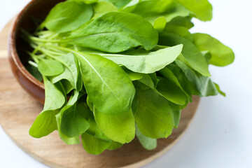 Fresh green Arugula on white background.