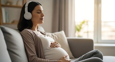 Pregnant woman wearing headphones listening to music