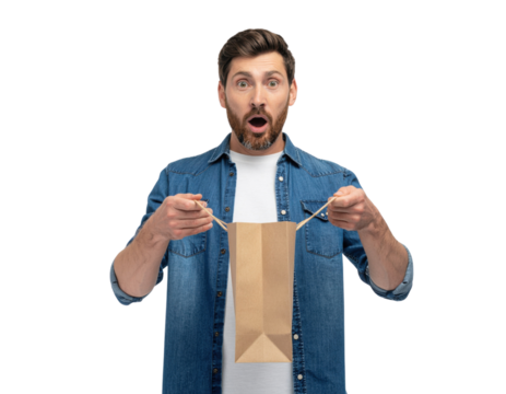A surprised man holds a paper bag, expressing excitement and curiosity about its contents.