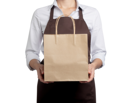 A person holds a brown paper shopping bag, wearing an apron, suggesting a retail or food service context. - Powered by Adobe