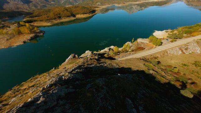 FPV drone view of Porma reservoir and autumn valley