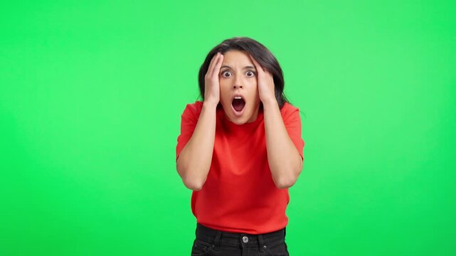 Surprised woman reacting in shock on green screen