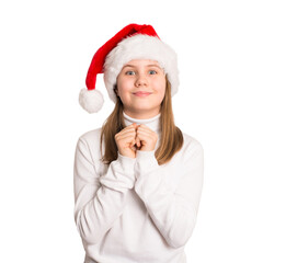 Preteen girl in Santa hat and white sweater holding hands near heart, waiting for a present or miracle. Perfect for Christmas hope, holiday wish, or festive emotion concepts.