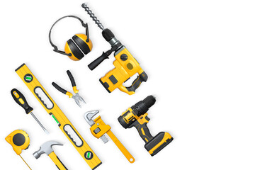 Assorted construction tools including drill, hammer, tape, wrench, and earmuffs isolated on white background, concept of DIY
