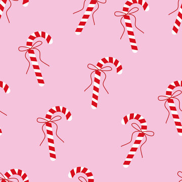Candy cane seamless pattern with red bows on pink background, Christmas sweet decoration, flat vector illustration