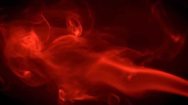 Red smoke on black background shows abstract fluid motion this is a very beautiful and mysterious vapor cloud this is a great creative and dynamic design this is a great passion concept