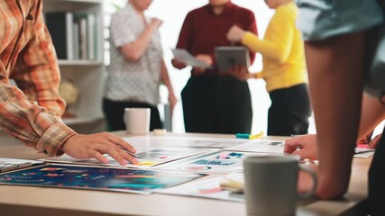 A diverse group of professionals is engaged in a vibrant office meeting, collaborating on project strategies using charts and documents to foster creativity and solutions. SACTR - Powered by Adobe