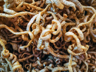 Texture delicious pieces of pork rind, Pork scratching, Crispy pork crackling or deep fried pork skin or of Kap Moo background. 
Delicious chicharrones, showcasing their golden, crunchy texture.