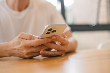 person using a modern smartphone indoors, emphasizing communication, technology daily digital lifestyle in a relaxed environment.