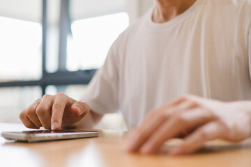 person using a modern smartphone indoors, emphasizing communication, technology daily digital lifestyle in a relaxed environment.