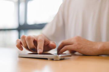 person using a modern smartphone indoors, emphasizing communication, technology daily digital lifestyle in a relaxed environment.