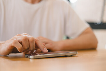 person using a modern smartphone indoors, emphasizing communication, technology daily digital lifestyle in a relaxed environment.