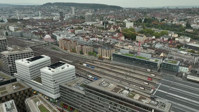 day time zurich city center train station railways famous modern office complex exterior aerial panorama 4k switzerland      