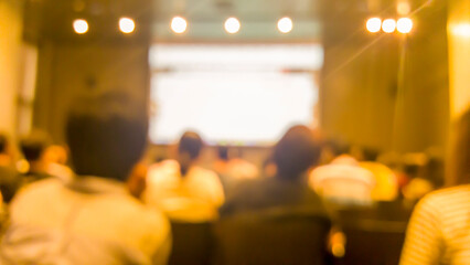 Blurred background people join seminar business event in auditorium hall convention.  Presentation...
