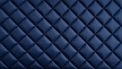 Obraz premium Quilted navy fabric diagonal texture, featuring soft padding, geometric diamond shapes, and a modern textile surface for fashion, upholstery, or backgrounds.