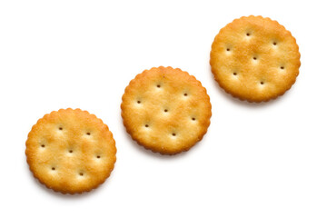 Three round biscuits diagonally on a white background. Three crackers isolated