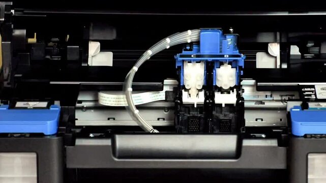 Gloved technician carefully adjusts blue ink cartridge during printer system repair, showcasing precise handling, internal components, and maintenance workflow in close-up detail