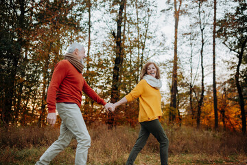Senior couple enjoying autumn walk in nature,