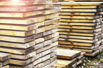 Stack of fresh pine boards in a sawmill warehouse. Harvesting, sale of lumber for construction
