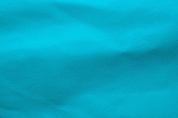 Obraz premium Abstract turquoise fabric background with subtle texture and soft folds