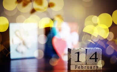 Wooden calendar 14th of February on bokeh background