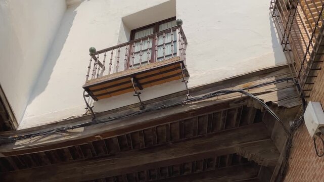 Slow-motion descending shot revealing the archway and traditional Castilian architecture in La Puebla de Montalb&aacute;n, Toledo. Brick, stone, and wood elements reflect Spain&rsquo;s rich architectural heritage.