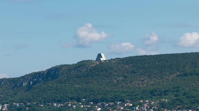 Temple of Monte Grisa, modern architecture on hilltop overlooking forest, Trieste, Italy. Aerial drone, copy space