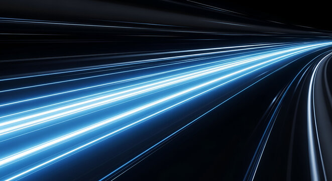 Abstract image of glowing blue light trails speeding through the darkness