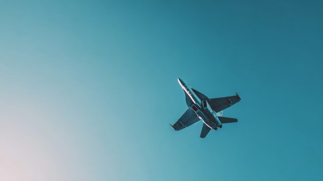 A dynamic fighter jet soaring through a clear blue sky, showcasing its impressive aerodynamic design. - Powered by Adobe